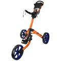 A golf push cart features orange and blue colors with three wheels and a handle for steering positioned over a flat surface designed for transporting golf clubs and accessories.