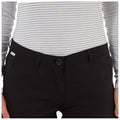 A person is wearing a fitted striped long-sleeve top and black pants featuring a button closure and side pockets against a plain background.