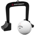 A black golf alignment guide stands upright above a white Callaway golf ball marked with the number one positioned on a flat surface, indicating preparation for a shot during practice.