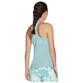A woman with a braided hairstyle is wearing a light blue athletic tank top and patterned leggings while facing away, showcasing a sporty outfit suitable for exercise or casual activities.