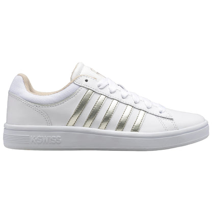 A white sneaker with metallic silver stripes is positioned sideways with laces tied. The sneaker has a clean, modern design and is set against a plain background.