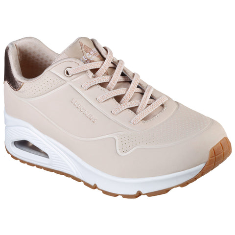 A beige athletic shoe with a smooth design and mesh accents features light laces and a cushioned sole its context is a neutral background highlighting the shoe's details and style