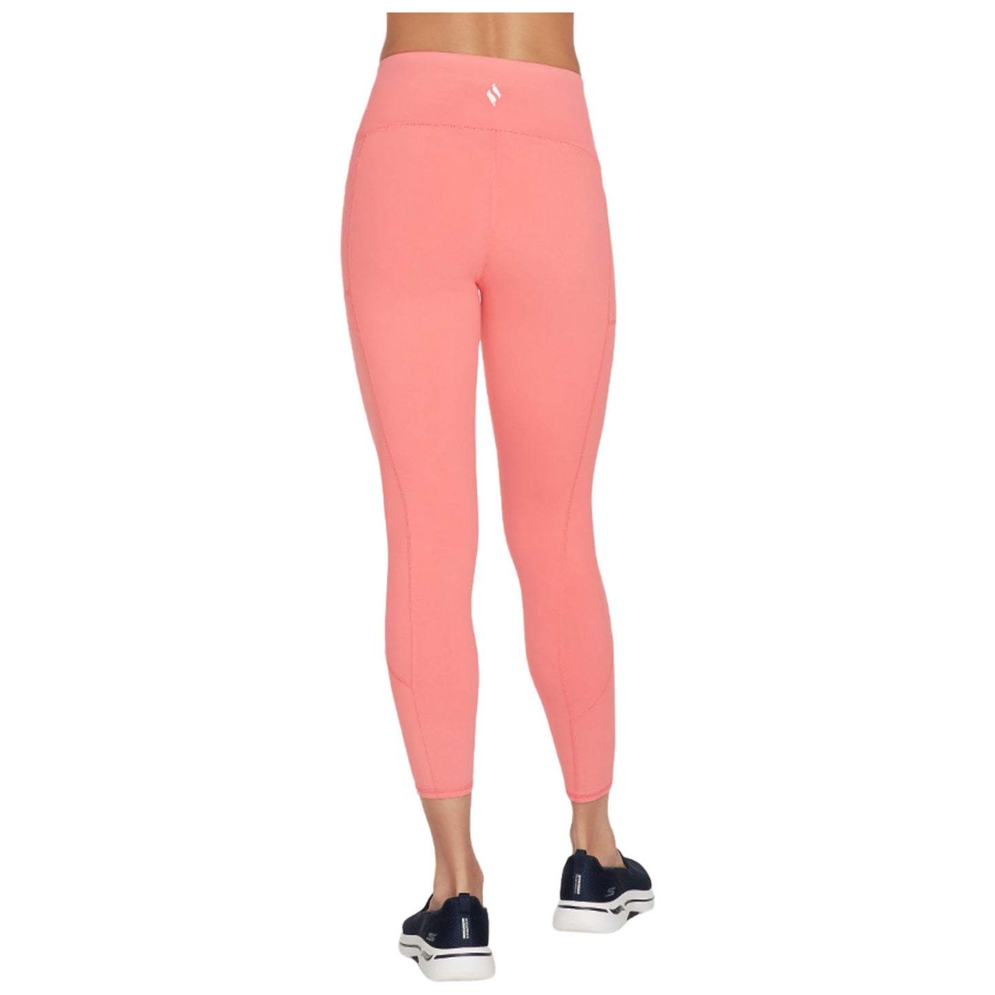 A person is wearing bright pink leggings that fit snugly, standing in a neutral environment with no other visible elements, featuring a smooth fabric and a high waistband.