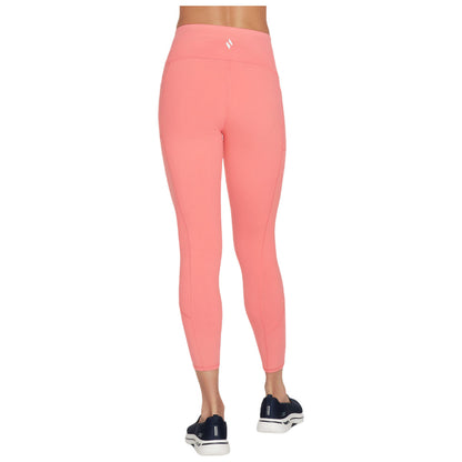 A person is wearing bright pink leggings that fit snugly, standing in a neutral environment with no other visible elements, featuring a smooth fabric and a high waistband.