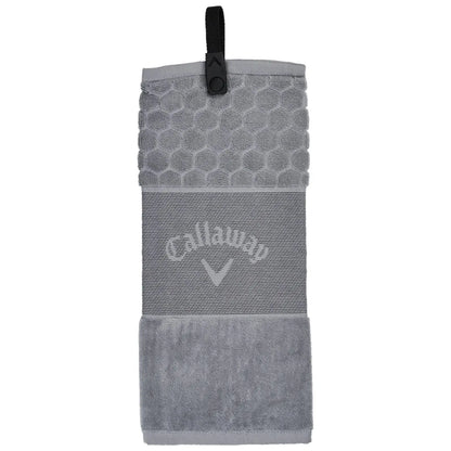 A grey golf towel hangs vertically featuring a textured hexagonal top and a soft lower section with a logo. It is equipped with a clip for easy attachment during play.