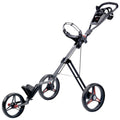 A black and red golf push cart features three wheels with a handle for steering and a compartment for carrying golf bags on a flat surface designed for outdoor use.
