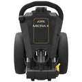 A black golf trolley stands upright featuring a handle at the top and large wheels below it designed for easy maneuverability on golf courses. It is compact and functional.