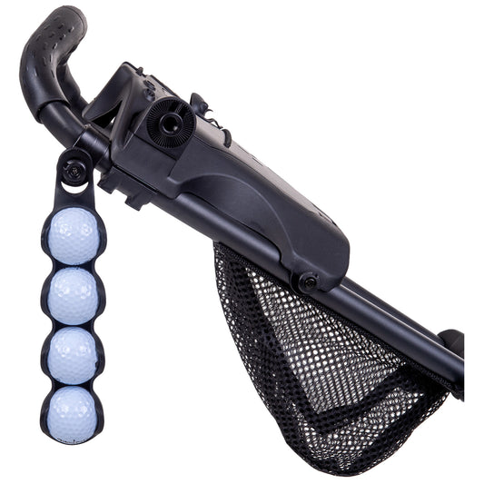 A black golf push cart has a textured handle with a golf ball holder attached featuring four white golf balls while a black mesh storage net hangs below in an outdoor context.