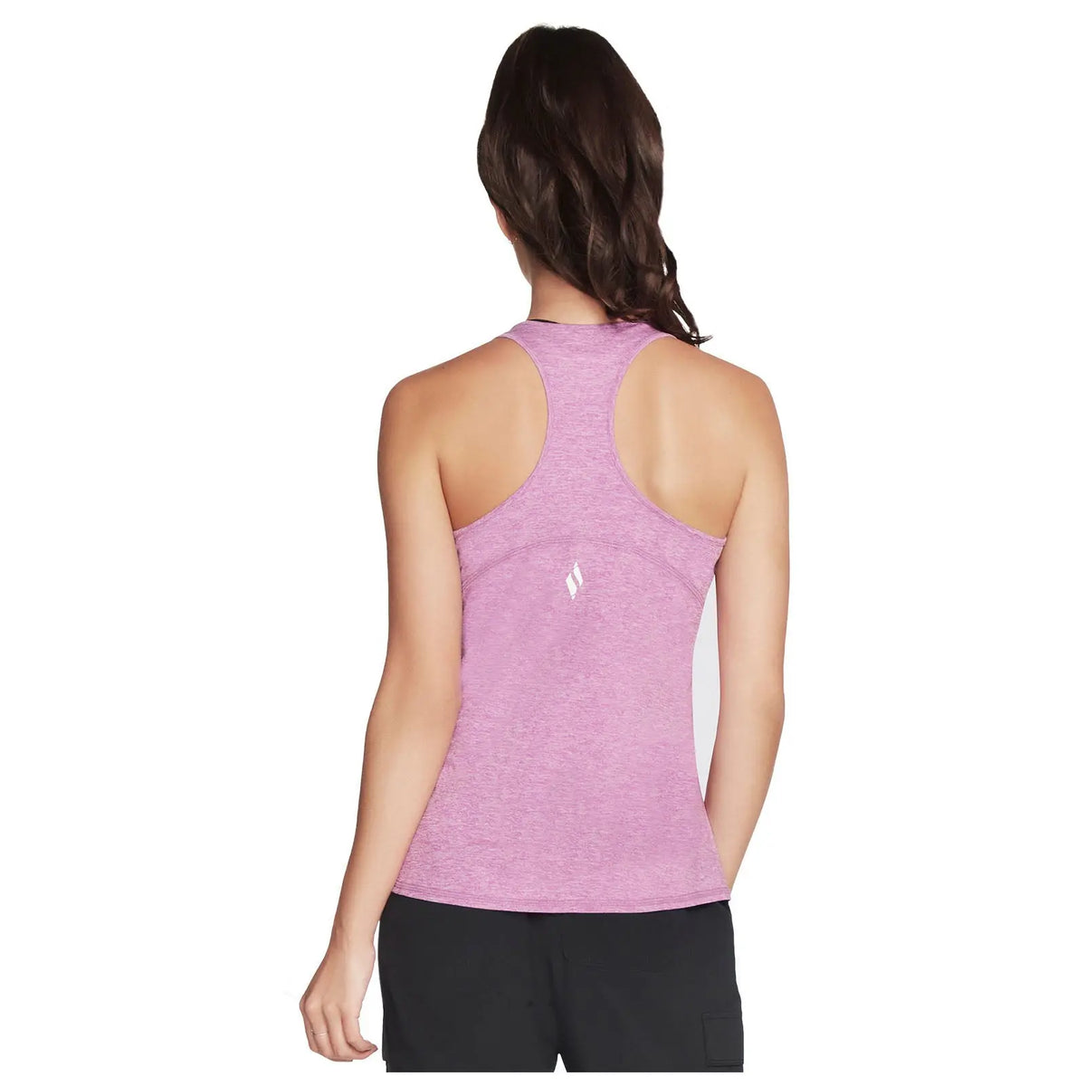 A pink athletic tank top is displayed on a model facing away showcasing the racerback design while wearing black shorts in a minimalist white background