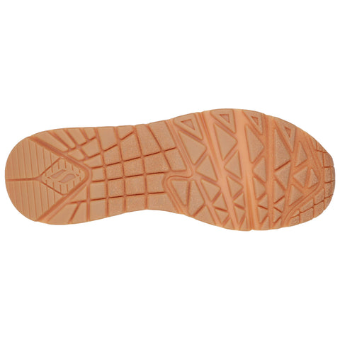 A shoe sole features textured patterns designed for grip and traction showcasing an orange hue against a plain background suggesting suitability for outdoor activities or sports.