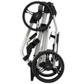 A lightweight stroller is folded for storage showcasing its compact design with two large wheels and a streamlined frame suitable for easy transportation in various environments.