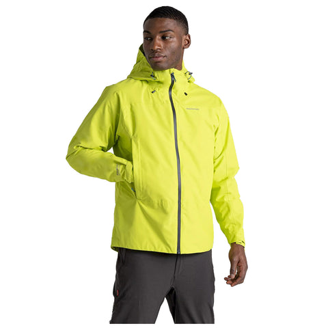 A man wears a bright yellow jacket with a hood and zipper while standing with one hand in his pocket. He is posed against a plain white background.