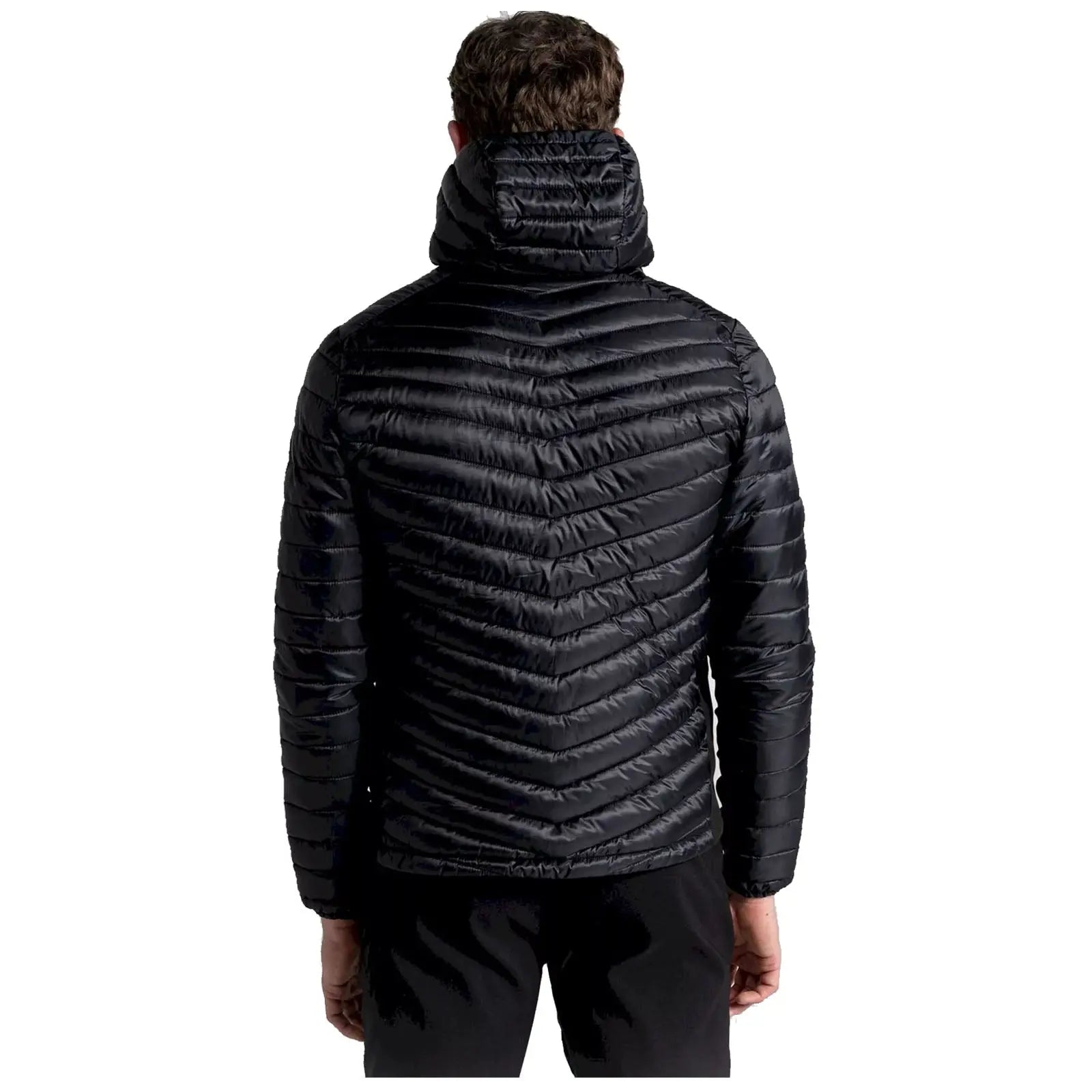 A person wearing a black puffer jacket is standing with their back facing the viewer the jacket features a chevron pattern and a high collar, set against a plain background.