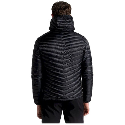 A person wearing a black puffer jacket is standing with their back facing the viewer the jacket features a chevron pattern and a high collar, set against a plain background.