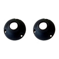 Two black spherical objects with a central hole and three smaller holes around the edge are placed side by side on a white background.