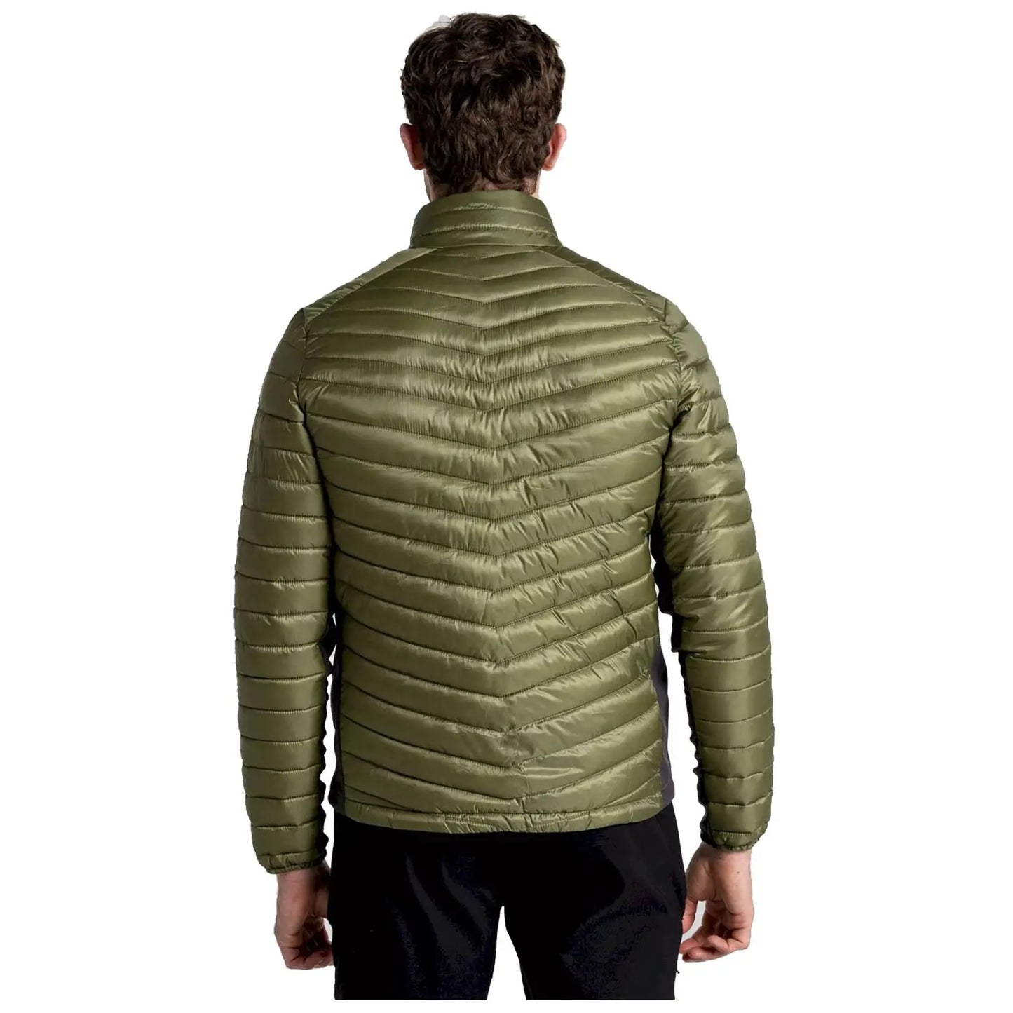 A man is wearing a green puffer jacket, standing with his back to the viewer in a neutral setting, highlighting the jacket's textured and padded design.