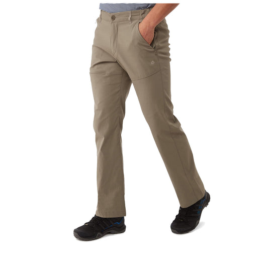 Craghoppers Mens Kiwi Pro II Walking Trousers Khaki pants worn by a person standing with one hand in a pocket and the other relaxed at their side in a neutral setting without visible background details.