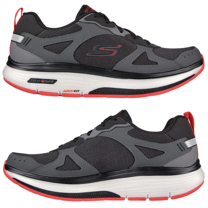 A black and gray athletic shoe with red accents rests against a white background featuring a mesh upper and cushioned sole designed for comfort and support during workouts. A pair of athletic shoes features a grey and black design with red accents. The shoes are positioned to showcase their mesh and synthetic material, ideal for comfort and support in physical activities.