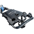 A black and blue portable device with handles and various holders designed for convenience is positioned for use in an active environment like a sports field or beach.