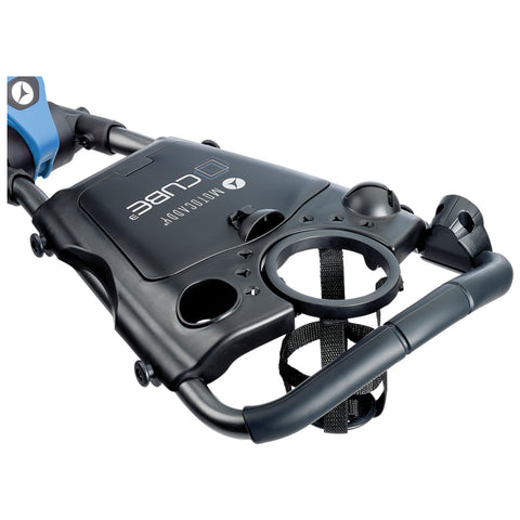 A black and blue portable device with handles and various holders designed for convenience is positioned for use in an active environment like a sports field or beach.
