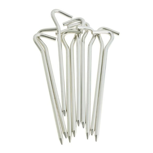 A group of metal tent stakes stands upright with pointed ends for securing tents or fabric to the ground in outdoor camping or event settings, emphasizing stability and durability.