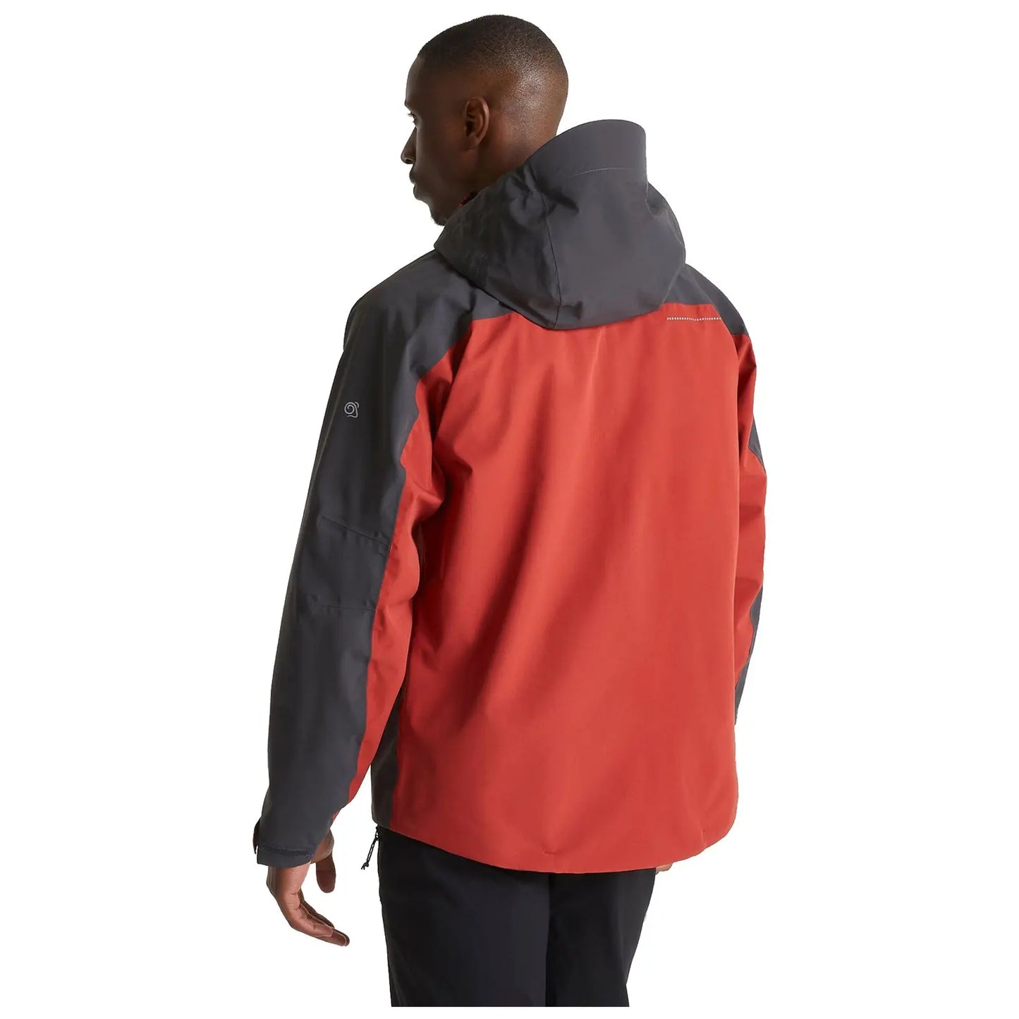 A person is wearing a red and gray jacket with a hood while facing away in a neutral background conveying a casual outdoor or adventure context.