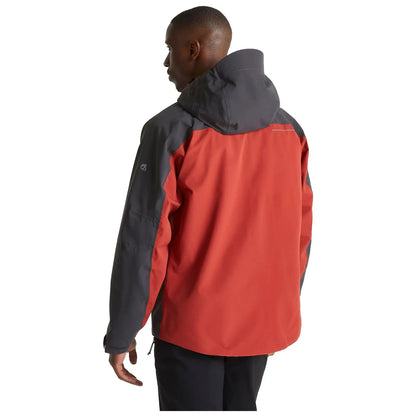 A person is wearing a red and gray jacket with a hood while facing away in a neutral background conveying a casual outdoor or adventure context.