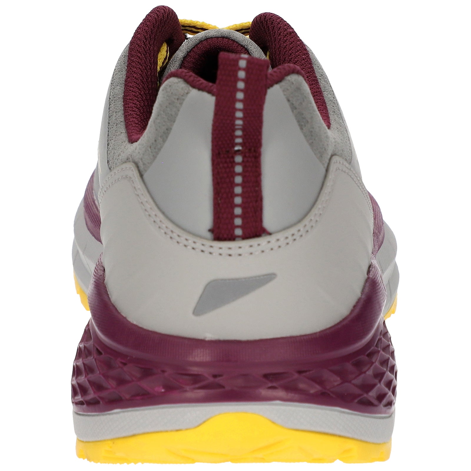 A sneaker is positioned upright with a focus on its back features showcasing a gray upper section maroon accents and a textured yellow rubber sole emphasizing its athletic design.