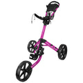A pink golf cart is displayed standing upright on three large black wheels with a foot pedal and a mesh storage area at the top designed for carrying golf equipment.