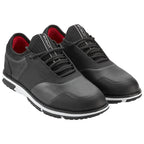 Black athletic shoes are positioned side by side with laces threaded and the interior showcasing a red lining against a plain background, highlighting their design and style suitable for active wear.