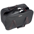 A black bag with red trim contains a compact object partially visible inside it suggesting it is being stored or transported in a casual setting.