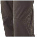 A pair of dark pants is shown with a focus on the knee area highlighting stitching and fabric texture in a neutral background setting.