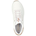 A white sneaker with perforated details and light laces sits upright showcasing the cushioned insole embossed with Skechers branding and a tan accent at the heel