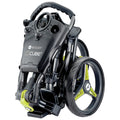 A compact black stroller is folded with a sleek design features a distinctive handle and stylish wheels with bright green accents indicating ease of transport and storage.