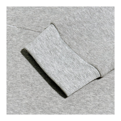 A gray sweatshirt is displayed prominently showing a close-up of a cuff where the fabric appears soft and textured against a uniform gray background.