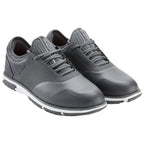 Stylish gray golf shoes feature a sleek design with a textured surface and lace-up closure positioned on a white and black contrasting sole suitable for use on the golf course.