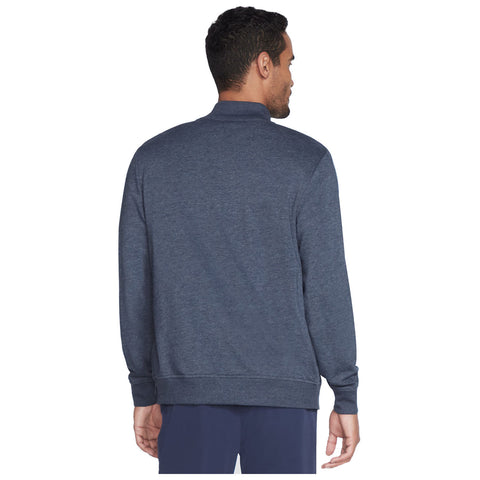 A man wearing a dark blue sweater stands with his back to the viewer in a neutral setting, showcasing the garment’s design and fit without any prominent distractions surrounding him.