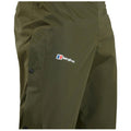 An olive green waterproof pant is displayed featuring a logo from the brand Berghaus on the front side and snap closures along the side for secure fastening.