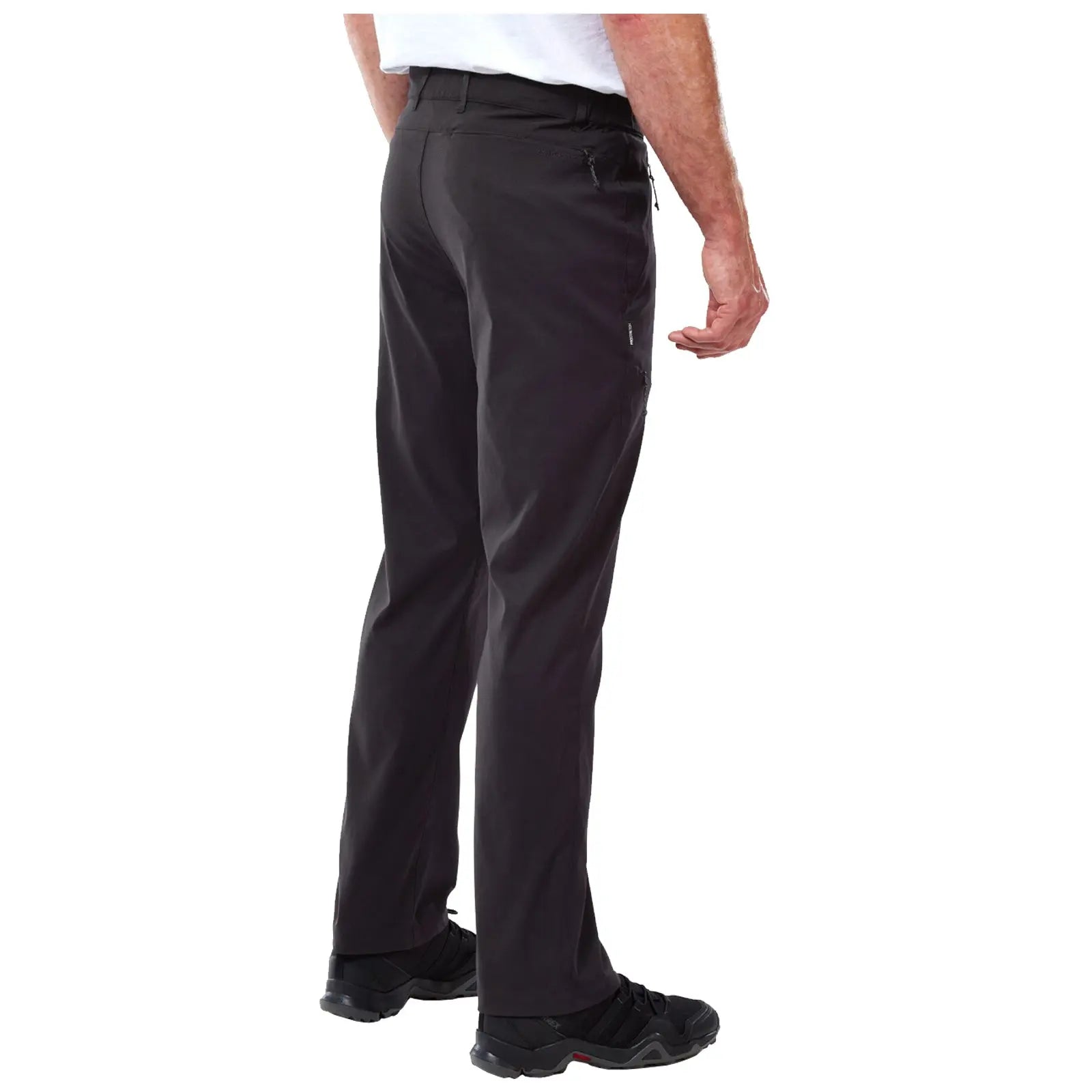 Black pants are worn by a person standing with their back facing the viewer. The setting appears neutral with no distinct background elements visible. The person is wearing black footwear.