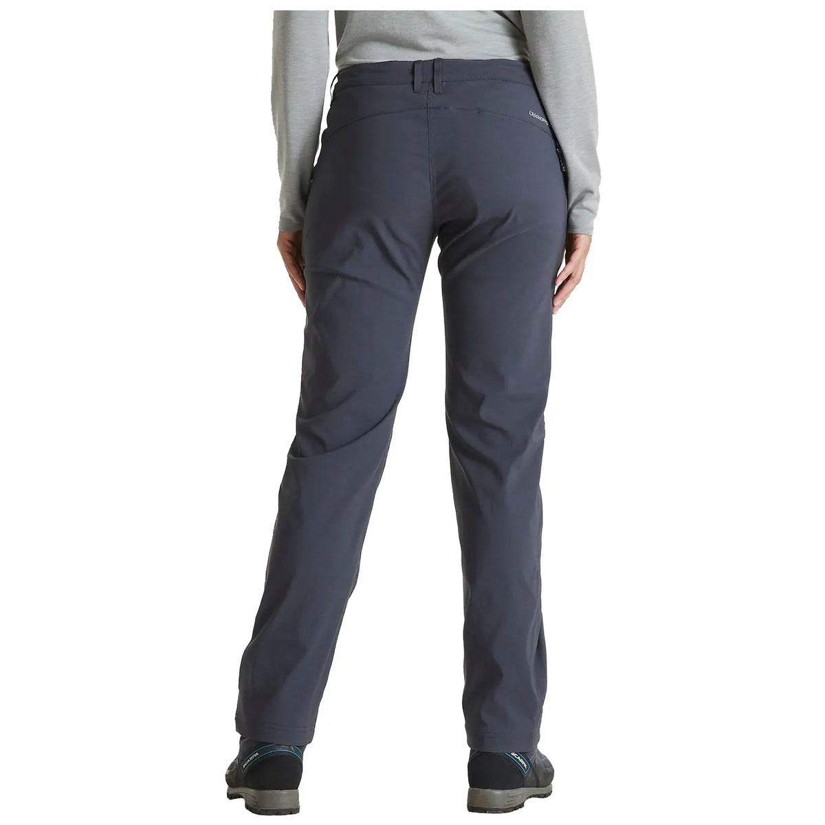 Gray outdoor pants are worn by a person standing with their back facing the viewer in a neutral setting suggesting comfort and readiness for activities in nature.