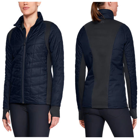 A woman wears a fitted navy jacket with quilted texture and black side panels showcasing a front zipper and high collar in a neutral background.