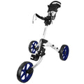 A golf push cart with a white frame and blue wheels is positioned upright with a handle at the top for pushing while supporting a golf bag in a sporty outdoor setting.
