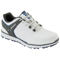 A white athletic shoe with gray and blue accents is positioned at an angle showcasing its laces and spiked sole designed for traction on grass or turf.