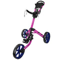 A pink golf push cart with three wheels is positioned upright showcasing its handle and a mesh storage compartment while standing on a flat surface, ready for use on a golf course.