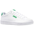 A white sneaker is displayed with green accents and branding The sneaker has a smooth texture and features laces with a logo on the tongue suggesting a sporty style
