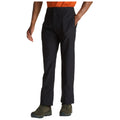 Black pants feature a casual fit and a slight sheen while a person stands with one hand in the pocket and the other relaxed at their side in a neutral setting.