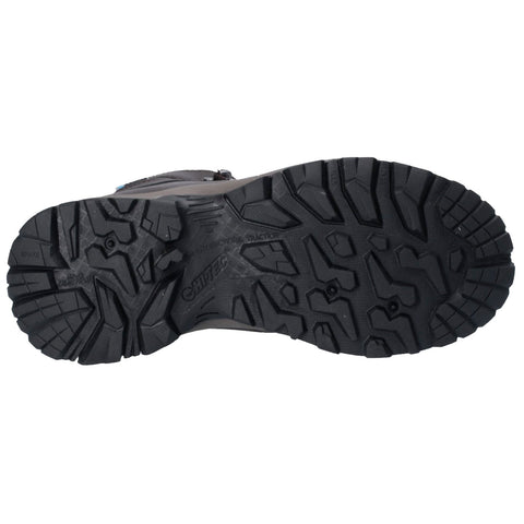 A hiking boot sole is shown resting flat on a surface showcasing deep treads designed for traction with a rugged texture indicating durability and grip for outdoor terrain.