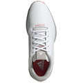 A white athletic shoe with a smooth leather surface and a gray and red inner lining is displayed from an overhead perspective highlighting the laces and branding.
