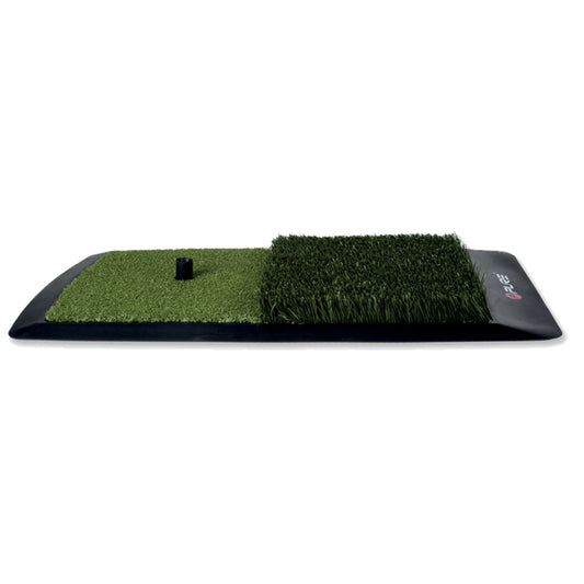 A rectangular mat features two sections of artificial grass with varying heights and a central black cylindrical peg. The mat is designed for training or practice purposes in a sports setting.