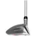 A golf club head is positioned upright showcasing a sleek design with a shiny surface the brand name TaylorMade is visible along with the word RESCUE emphasizing its purpose in playing golf.